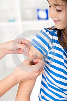 Nurse putting a plaster over the wound