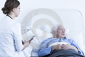 Nurse reading book to patient