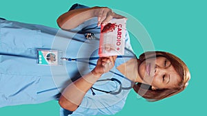 Nurse reading info on medicine package