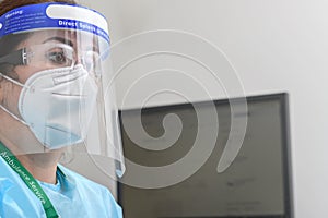 Nurse's close-up protrait with protective glasses and N95 mask