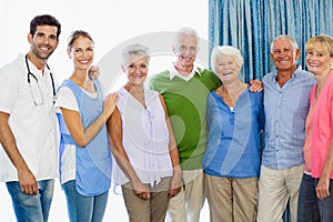 Nurse and seniors standing together