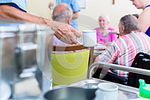 Nurse serving food in nursing home photo