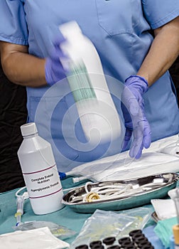 Nurse shaking enteral Nutrition bottle in a hospital, Palliative Care