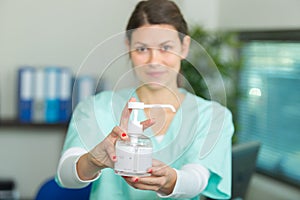Nurse showing alcohol gel pumper
