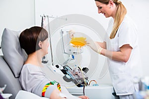 Nurse showing patient donating own blood her blood plasm