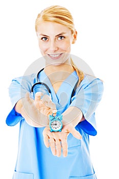 Nurse Showing Toy Alarm Clock Over White Background
