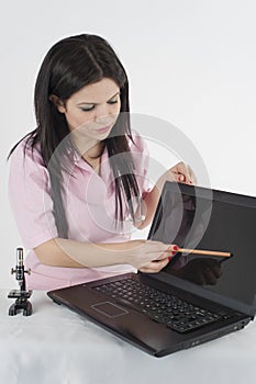 Nurse shows information on black screen on laptop