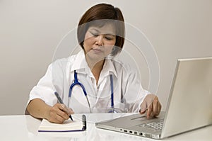 Nurse sitting and writing