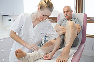 Nurse splint cast on leg patient in hospital