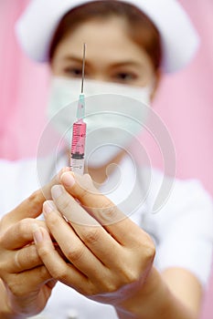 Nurse standing with syringe