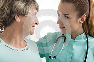 Nurse with stethoscope supporting woman