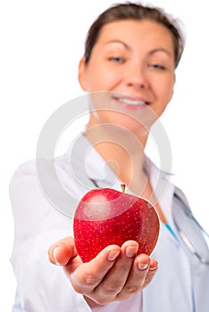 Nurse stretches ripe apple for health