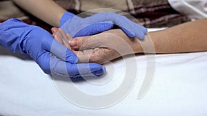 Nurse supporting and calming down patient before procedure caring hospital staff