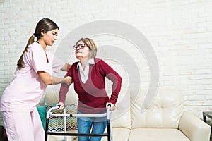 Nurse Supporting Elderly Patient At Home