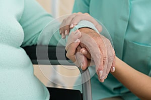 Nurse supporting old woman