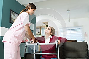 Nurse Supporting Senior Disabled Patient At Home photo