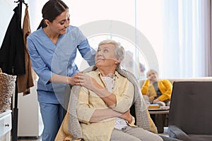 Nurse taking care of elderly woman in hospice