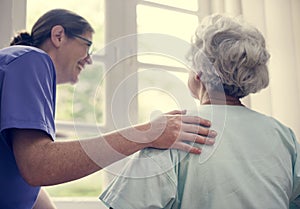 Nurse taking care of an old woman photo