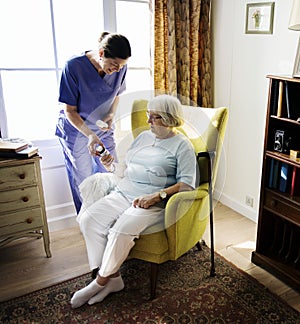 Nurse is taking care of a senior woman