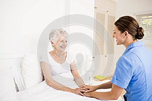 Nurse taking care of suffering senior patient