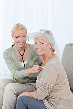 Nurse taking the heartbreat of her patient