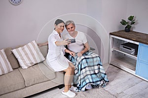 Nurse taking selfie with elderly patient.
