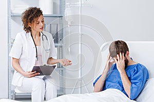 Nurse talking with paralyzed man