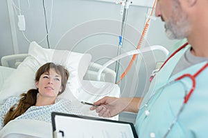 nurse talking with patient in hospital room