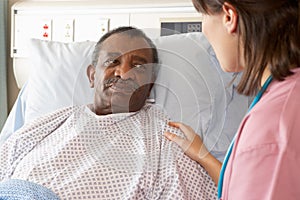 Nurse Talking To Male Patient On Ward photo