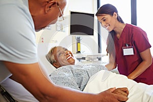 Nurse Talking To Senior Couple In Hospital Room