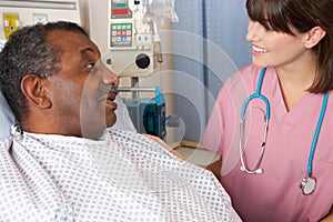 Nurse Talking To Senior Male Patient On Ward photo
