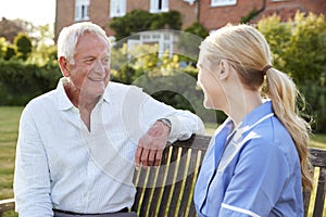 Nurse Talking To Senior Man In Residential Care Home