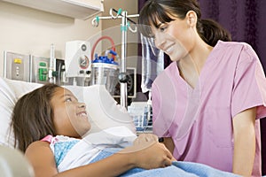 Nurse Talking To Young Patient