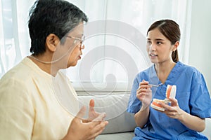 nurse teaches the elderly how to clean teeth at home