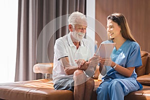 Nurse  teaching senior to use tablet