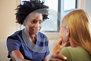 Nurse Treating Teenage Girl Suffering With Depression photo