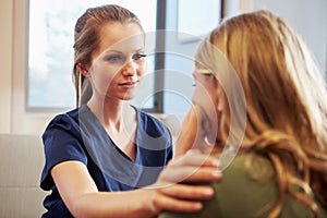 Nurse Treating Teenage Girl Suffering With Depression