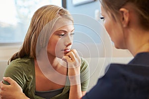 Nurse Treating Teenage Girl Suffering With Depression