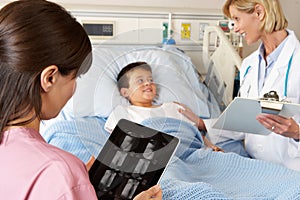 Nurse Using Digital tablet Whilst Visiting Patient
