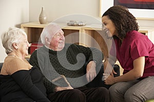 Nurse visiting senior couple at home