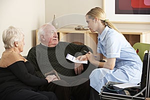 Nurse visiting senior couple at home