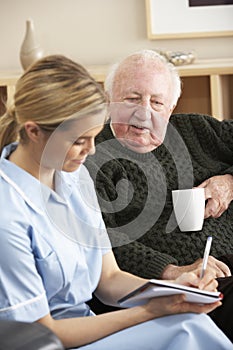 Nurse visiting senior man at home
