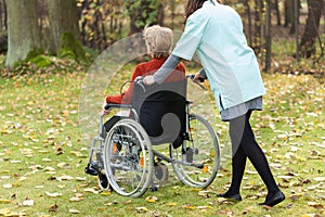 Nurse walking with disabled lady