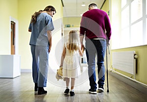 Nurse walking a patient down the hallway