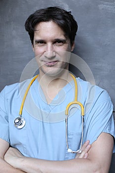 Nurse wearing blue scrubs and yellow stethoscope