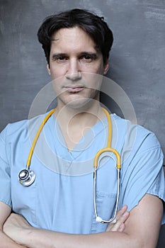 Nurse wearing blue scrubs and yellow stethoscope