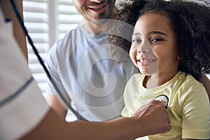 Nurse Wearing Uniform Listening To Girl Patient\'s Chest With Stethoscope In Private Hospital Room