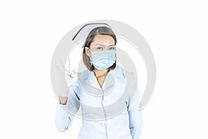 Nurse in white medical gown, sterile face mask showing OK gesture.