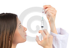 Nurse woman with medical syringe with needle