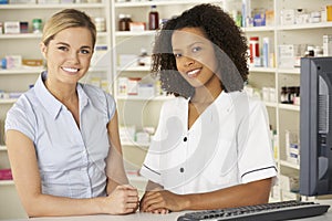 Nurse working on computer in pharmacy